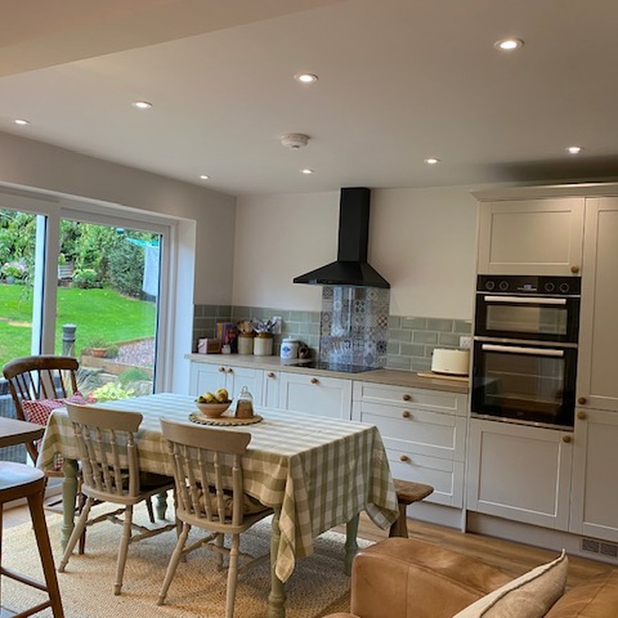 A person painted kitchen walls using a paintbrush and roller. The person applied the paint using Easy care Dulux paint onto the walls and woodwork