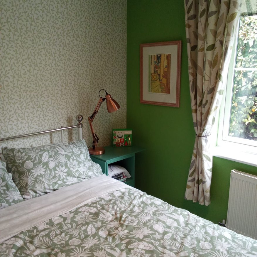 I painted green emulsion onto a bedroom wall and applied wallpaper onto a different wall Ledbury