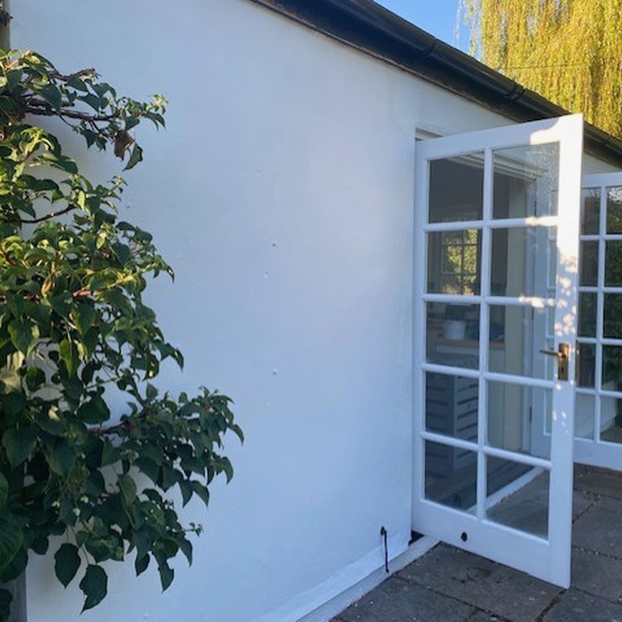I used a paintbrush to  paint white exterior satinwood onto the outside doors and window frames, Gloucestershire
